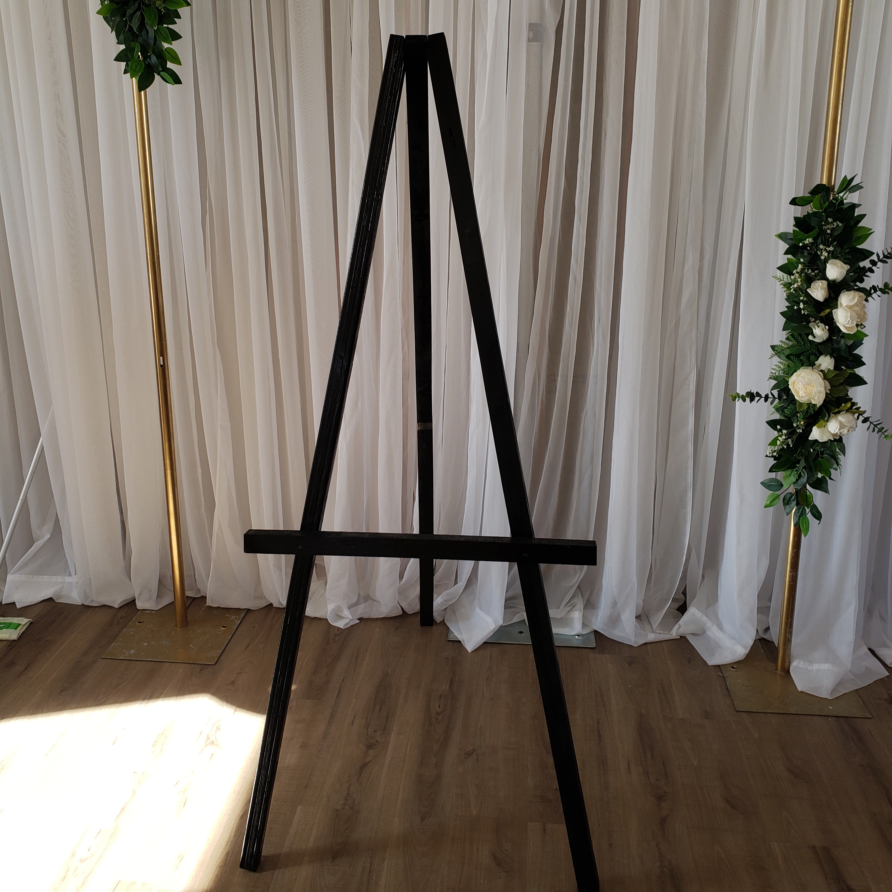 black easel for welcome signage and silk floral easel arrangements