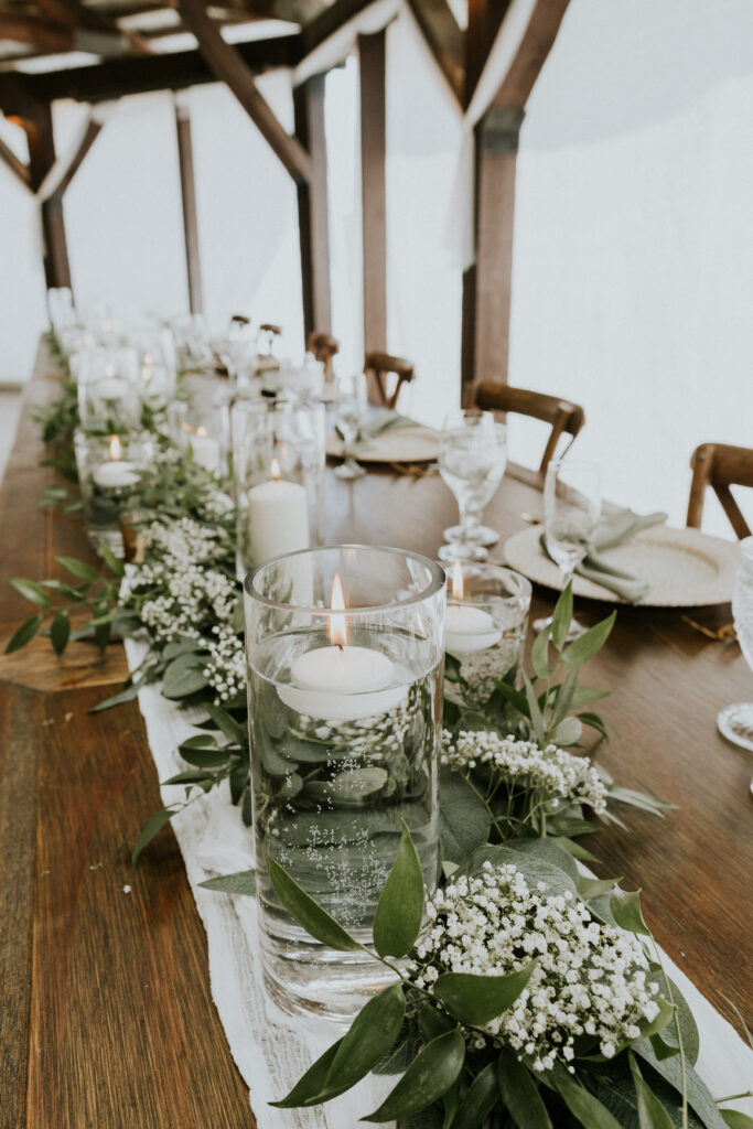 Elegant Cylinder Vases with Floating Candles: A Timeless Wedding Centrepiece.